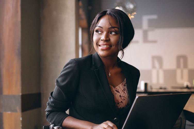 Picture of smiling Black girl using laptop